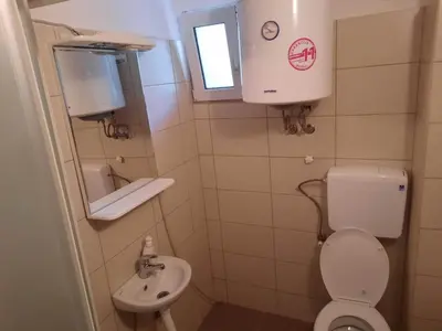 a small bathroom with a toilet and a sink at Panorama Borsko jezero in Beljevina