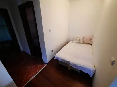 a small room with a small bed in the corner at Panorama Borsko jezero in Beljevina