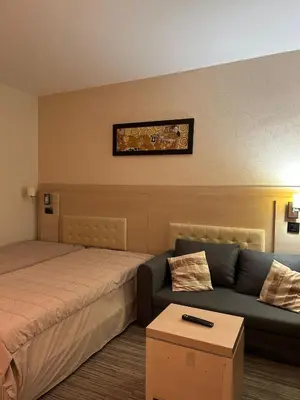 a hotel room with a bed and a couch at Konaci Sun in Kopaonik