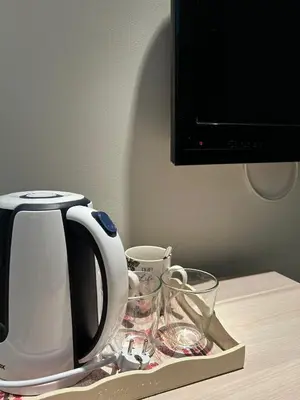 a coffee pot and glasses on a tray on a table at Konaci Sun in Kopaonik