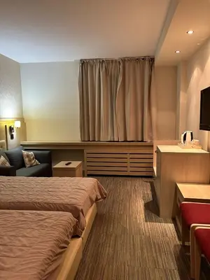 a hotel room with a bed and a couch at Konaci Sun in Kopaonik