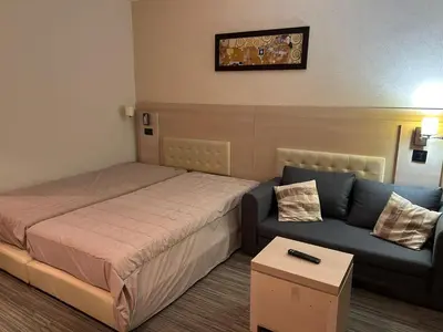 a hotel room with a bed and a couch at Konaci Sun in Kopaonik