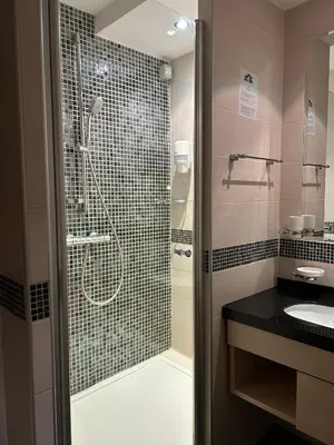 a bathroom with a shower and a sink at Konaci Sun in Kopaonik