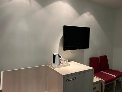 a room with a tv and a table and a chair at Konaci Sun in Kopaonik
