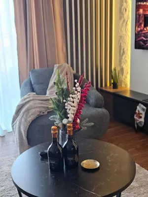 two bottles of wine on a table in a living room at Riviera Suite in Niš