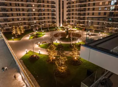 an overhead view of a courtyard with trees and lights at Riviera Suite in Niš