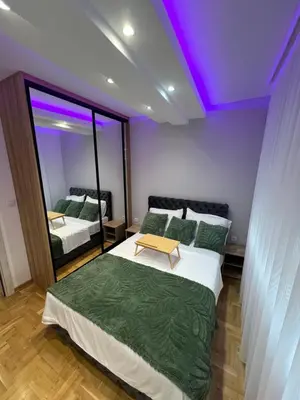 a bedroom with two beds and a purple ceiling at Apartman LaCasa Mia in Vrnjačka Banja