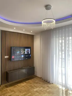 a living room with a flat screen tv on a wall at Apartman LaCasa Mia in Vrnjačka Banja