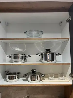 a shelf with pots and pans in a kitchen at Apartman LaCasa Mia in Vrnjačka Banja