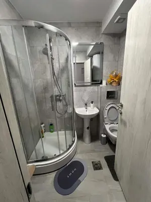 a bathroom with a shower and a toilet and a sink at Apartman LaCasa Mia in Vrnjačka Banja