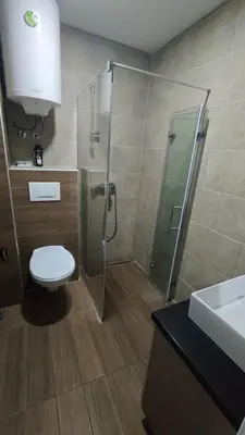 a bathroom with a shower and a toilet and a sink at Blistava Dolina S42 in Kopaonik