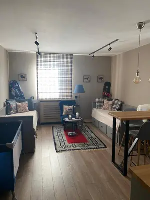 a living room with a couch and a table at Apartman Stemaks, Kopaonik in Kopaonik