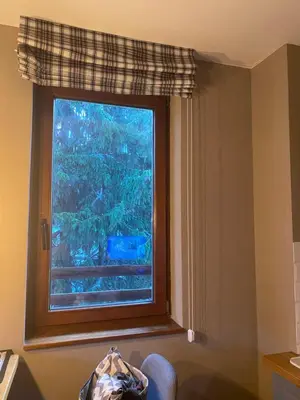 a window in a room with a chair in front of it at Apartman Stemaks, Kopaonik in Kopaonik