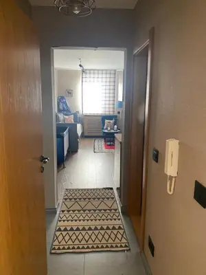 a hallway with a door open to a living room at Apartman Stemaks, Kopaonik in Kopaonik