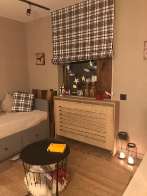 a room with a bed and a table and a window at Apartman Stemaks, Kopaonik in Kopaonik
