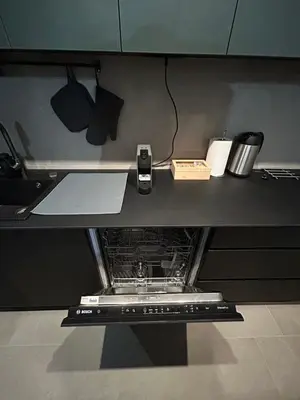 a kitchen counter with an electronic device on it at Tokyo88 Apartment in Niš