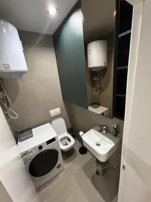 a small bathroom with a toilet and a sink at Tokyo88 Apartment in Niš