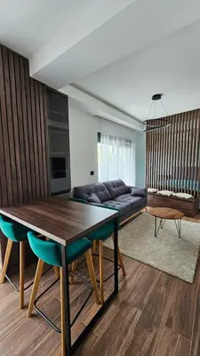 a living room with a table and a couch at Apartman Vrabac in Vrnjačka Banja
