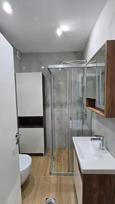 a bathroom with a shower and a sink and a toilet at Apartman Vrabac in Vrnjačka Banja