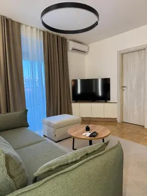 a living room with a couch and a table at Apartman La Campanella 2 in Vrnjačka Banja