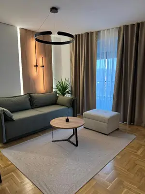 a living room with a couch and a table at Apartman La Campanella 2 in Vrnjačka Banja