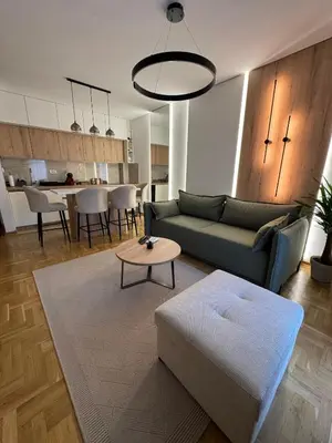 a living room with a couch and a table at Apartman La Campanella 2 in Vrnjačka Banja