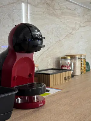 a red mixer sitting on top of a kitchen counter at Apartman La Campanella 2 in Vrnjačka Banja