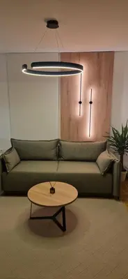 a living room with a couch and a coffee table at Apartman La Campanella 2 in Vrnjačka Banja