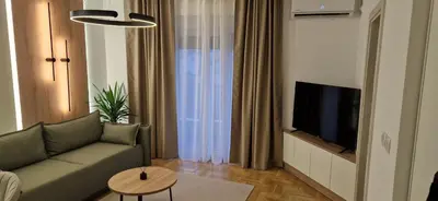 a living room with a couch and a flat screen tv at Apartman La Campanella 2 in Vrnjačka Banja