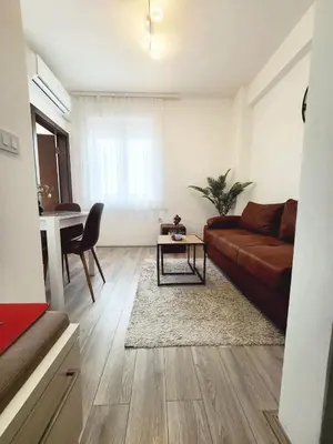 a living room with a couch and a table at Apartman Akva Park in Trnava