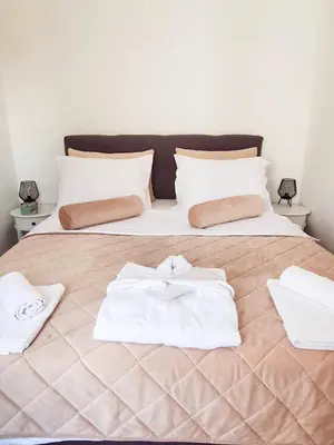 a bed with white towels on top of it at Apartman Akva Park in Trnava