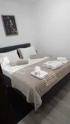 a large bed with towels and napkins on it at Apartman Akva Park in Trnava