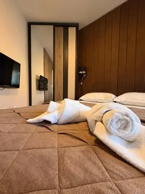 a hotel room with two towels on a bed at NAR Royalton Deluxe Apartment #74 Free Parking in Niš