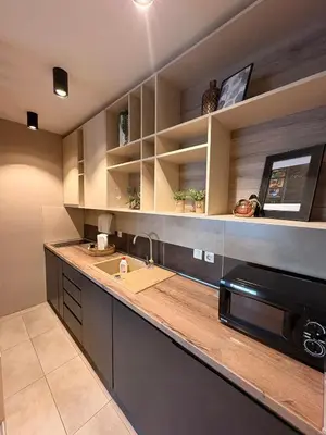 a kitchen with a sink and a microwave at NAR Royalton Deluxe Apartment #74 Free Parking in Niš
