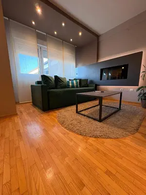 a living room with a green couch and a table at NAR Royalton Deluxe Apartment #74 Free Parking in Niš