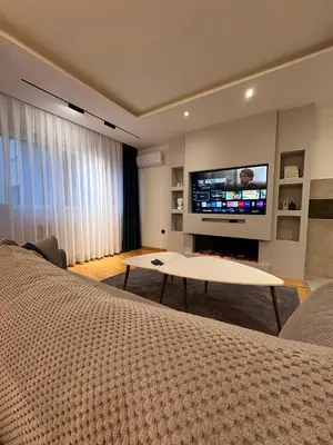 a living room with a bed and a tv at NAR Royalton Apartment #25 Free Parking in Niš