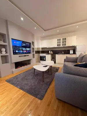 a living room with a couch and a table at NAR Royalton Apartment #25 Free Parking in Niš