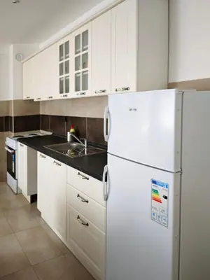 a kitchen with white cabinets and a white refrigerator at NAR Royalton Apartment #25 Free Parking in Niš