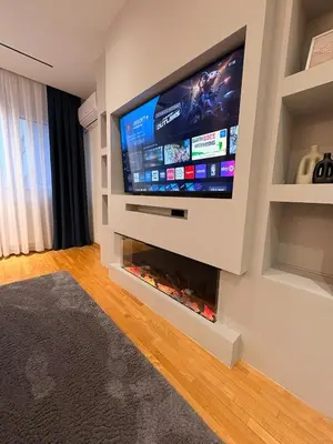 a living room with a flat screen tv on a wall at NAR Royalton Apartment #25 Free Parking in Niš
