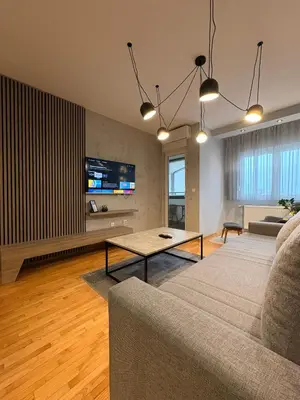 a living room with a couch and a table at NAR Royalton Apartment #76 Free Parking in Niš