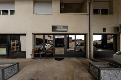 a building with a sign for a car dealership at NAR Royalton Apartment #76 Free Parking in Niš