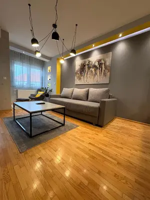 a living room with a couch and a table at NAR Royalton Apartment #76 Free Parking in Niš
