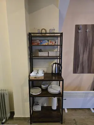a shelf with plates and utensils in a kitchen at Prime NG Mujen lux & spa in Cajetina