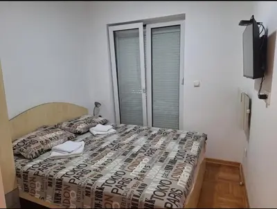 a bedroom with a bed with two towels on it at Apartman Štekić in Vrnjačka Banja