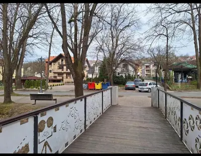 a wooden bridge over a street with cars on it at Apartman Štekić in Vrnjačka Banja