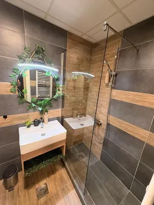 a bathroom with a sink and a shower at NAR Royalton Apartment #01 Free Parking in Niš