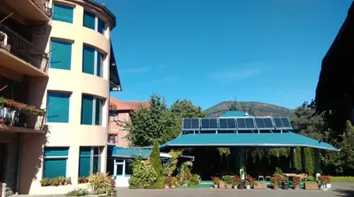 a building with a roof with solar panels on it at Bed & Breakfast Karavan in Raška
