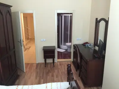 a bedroom with a bed and a dresser and a mirror at Bed & Breakfast Karavan in Raška