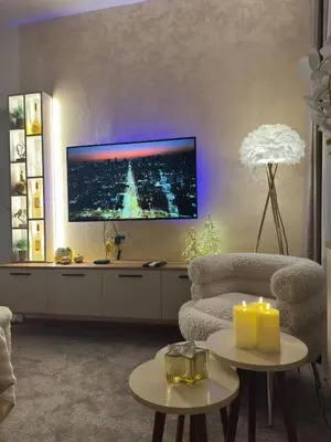 a living room with a tv on the wall at SpaNish FoROOM 1 in Niš
