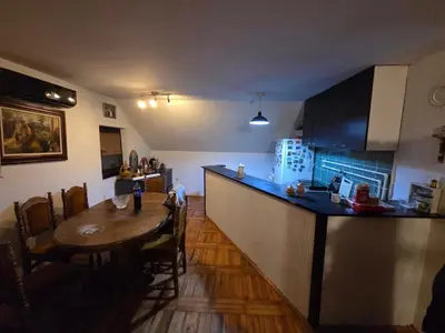 a kitchen and dining room with a table and a bar at Kuća Petrovic in Niška Banja